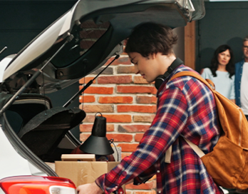 Teenage Boy loads his car's trunk